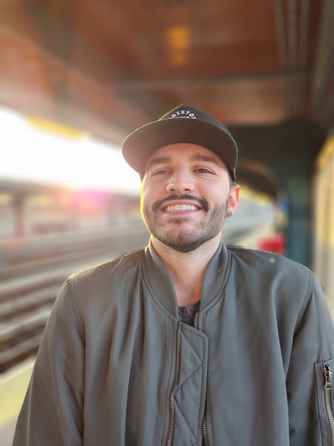 Shaun Cronin smiling on a New York subway platform